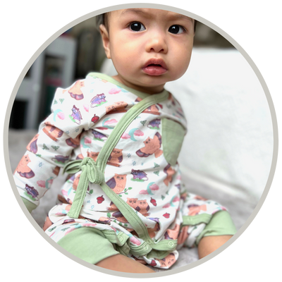 Gender-neutral baby rompers in organic cotton
